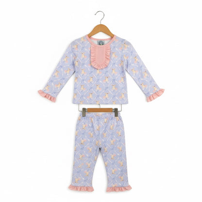 Grandmillennial Easter bunny girl pajama set with pink ruffle collar and sleeve details hanging on wooden hangers.