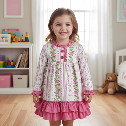 Smiling toddler girl standing in grandmillennial floral pink hearts nightgown with sweet ruffle hem and sleeve details.