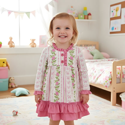 Toddler wearing the grandmillennial floral pink hearts girl nightgown with ruffles smiling in her bedroom setting.