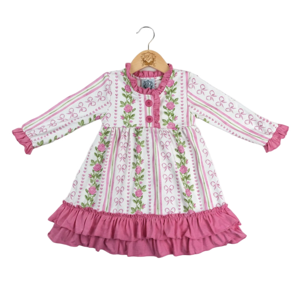 Grandmillennial floral pink hearts girl nightgown on a wooden hanger with pink ruffle hem trim and long sleeves.