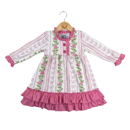 Grandmillennial floral pink hearts girl nightgown on a wooden hanger with pink ruffle hem trim and long sleeves.