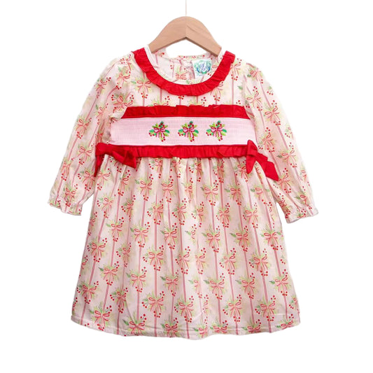 Grandmillennial Holly Berry Festive Bows Smocked Dress for girls, featuring red ruffle trim and embroidered smocking details.