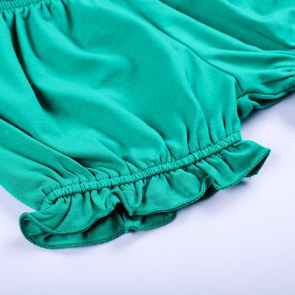 Detailed close-up view of soft green ruffle elastic leg opening on hand smocked toddler bloomer shorts.