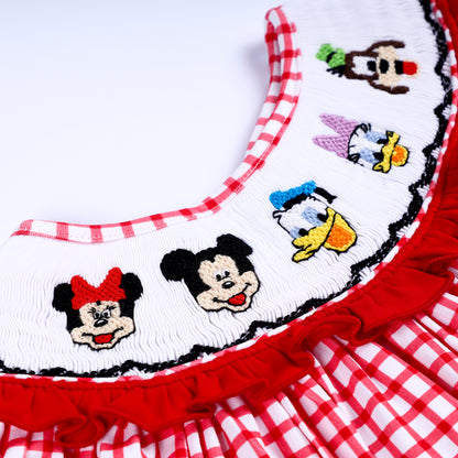 Detailed hand embroidered mouse and duck character heads on white smocked neckline of red gingham baby dress.