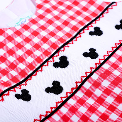 Detailed shot of hand embroidered black mouse shapes on white smocking trim of a red gingham boys jon jon outfit.