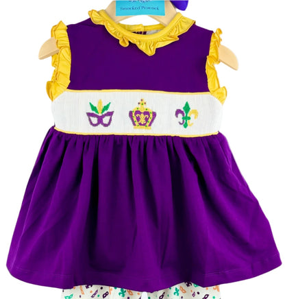 Hand-smocked Mardi Gras purple top with yellow ruffles and stitched mask, crown, and fleur-de-lis design.