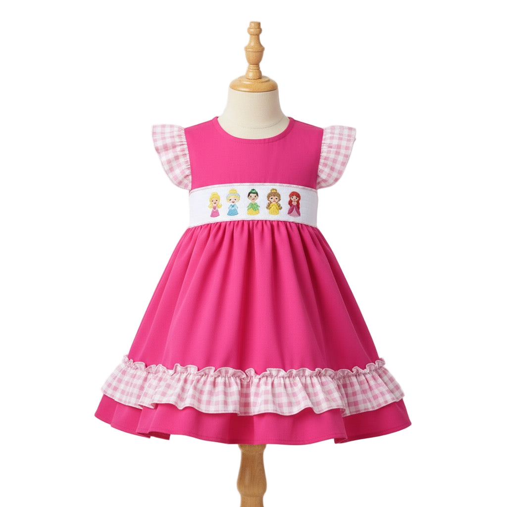 Hand smocked pink dress with embroidered princesses on the bodice and pink gingham ruffle trim and sleeves.