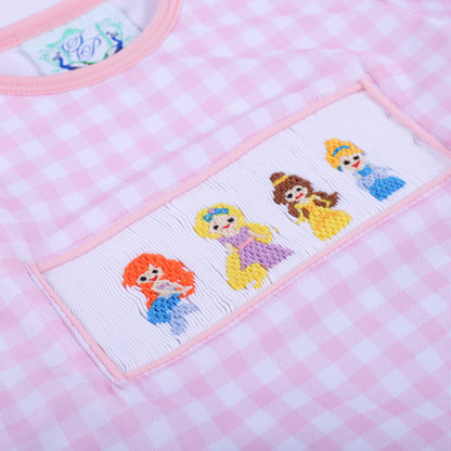 Angled close up view showcasing the detailed hand smocked fairytale princess embroidery on the girls gingham swim top.