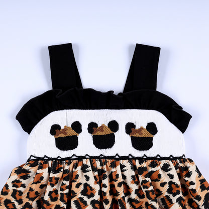 Front view close-up of hand smocked safari mouse with hat embroidery on white chest plate with animal print peplum.