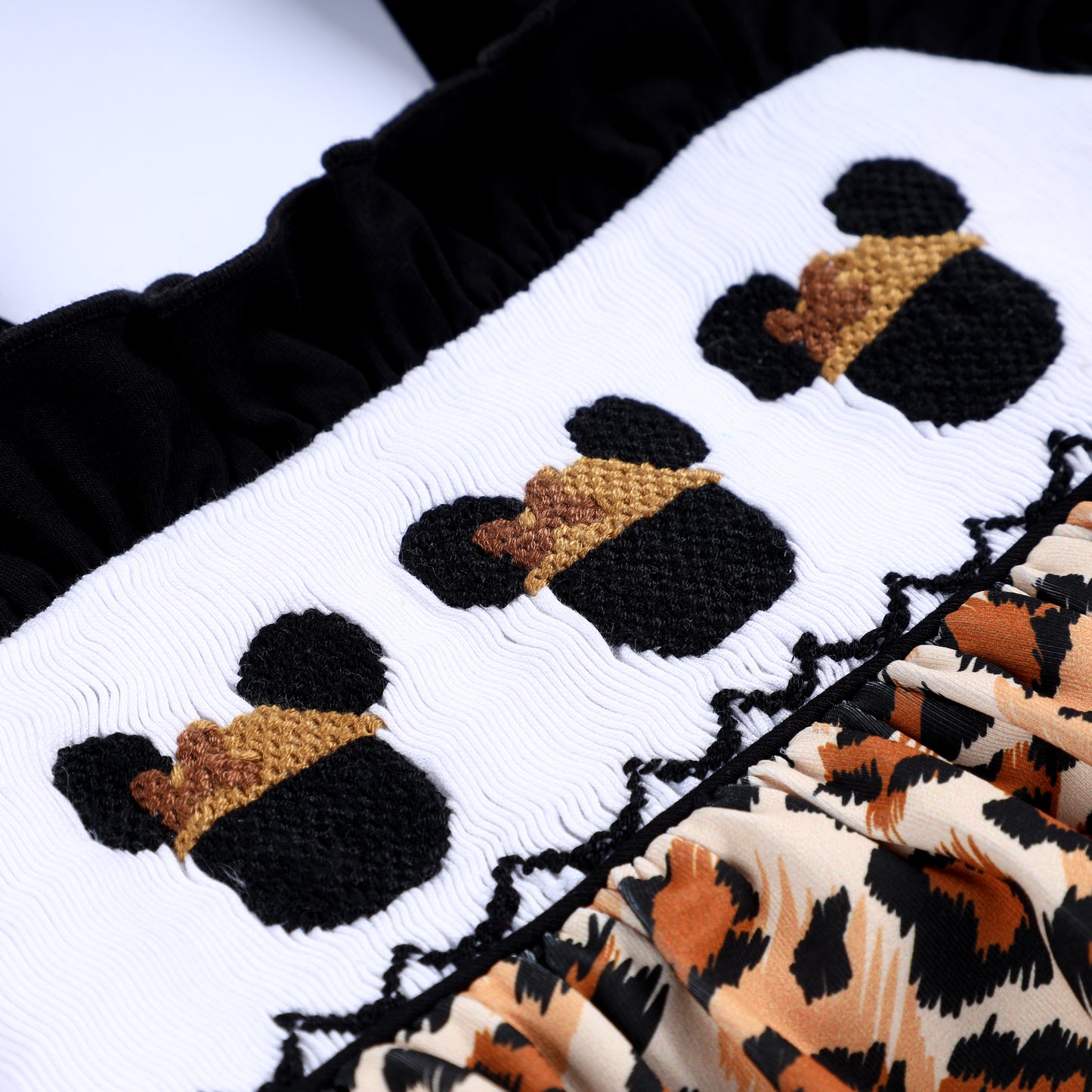 Close up of hand smocked stitching and embroidered safari mouse in safari hat on Animal Kingdom baby girl bubble.