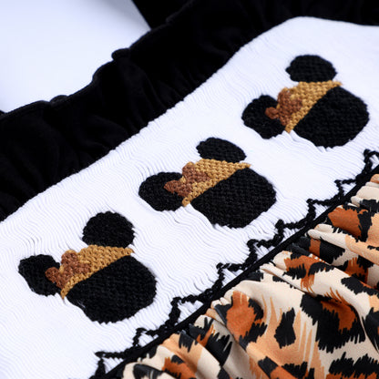 Close up of hand smocked stitching and embroidered safari mouse in safari hat on Animal Kingdom baby girl bubble.