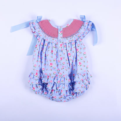 Back view of light blue floral hand smocked baby bubble with back button closures and tiered ruffles.