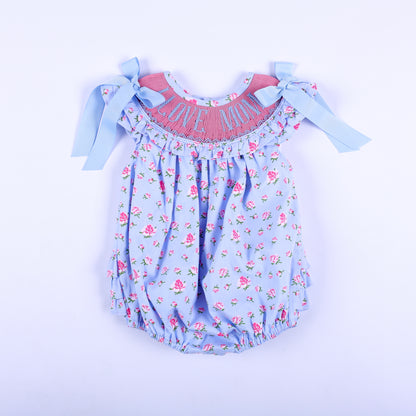 Light blue floral hand smocked baby bubble romper featuring I Love Mom embroidered pink yoke and shoulder bows.
