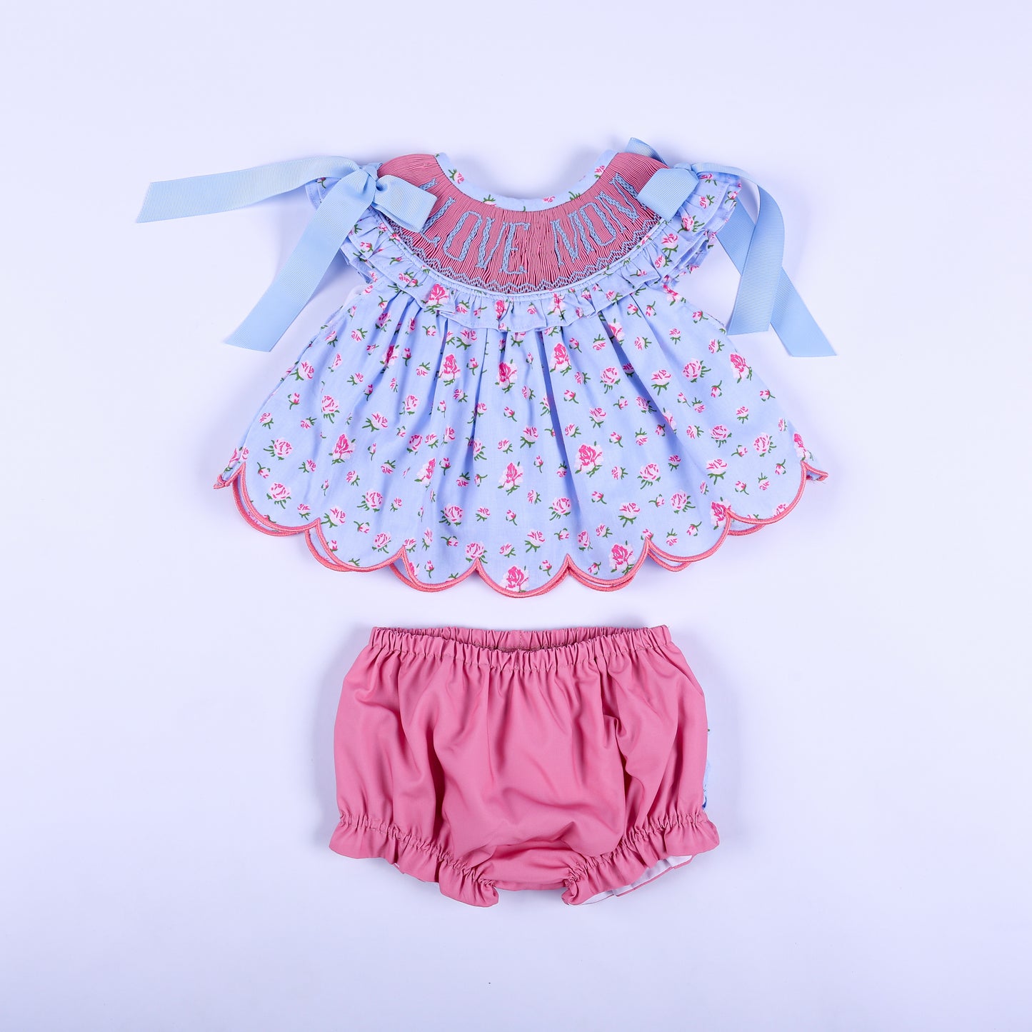 I Love Mom floral hand-smocked top and matching pink diaper cover bloomer set for baby girls, front view.