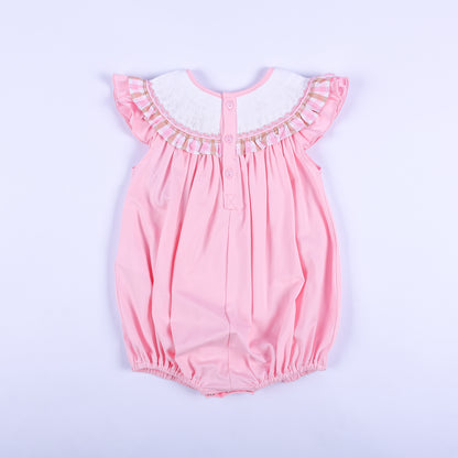 Full back view of a pink hand-smocked baby bubble outfit showing back button closure and ruffled flutter sleeves.
