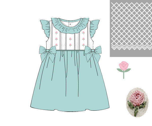 Hand-smocked ivory and mint girls dress featuring pink flower trellis embroidery and side bows.