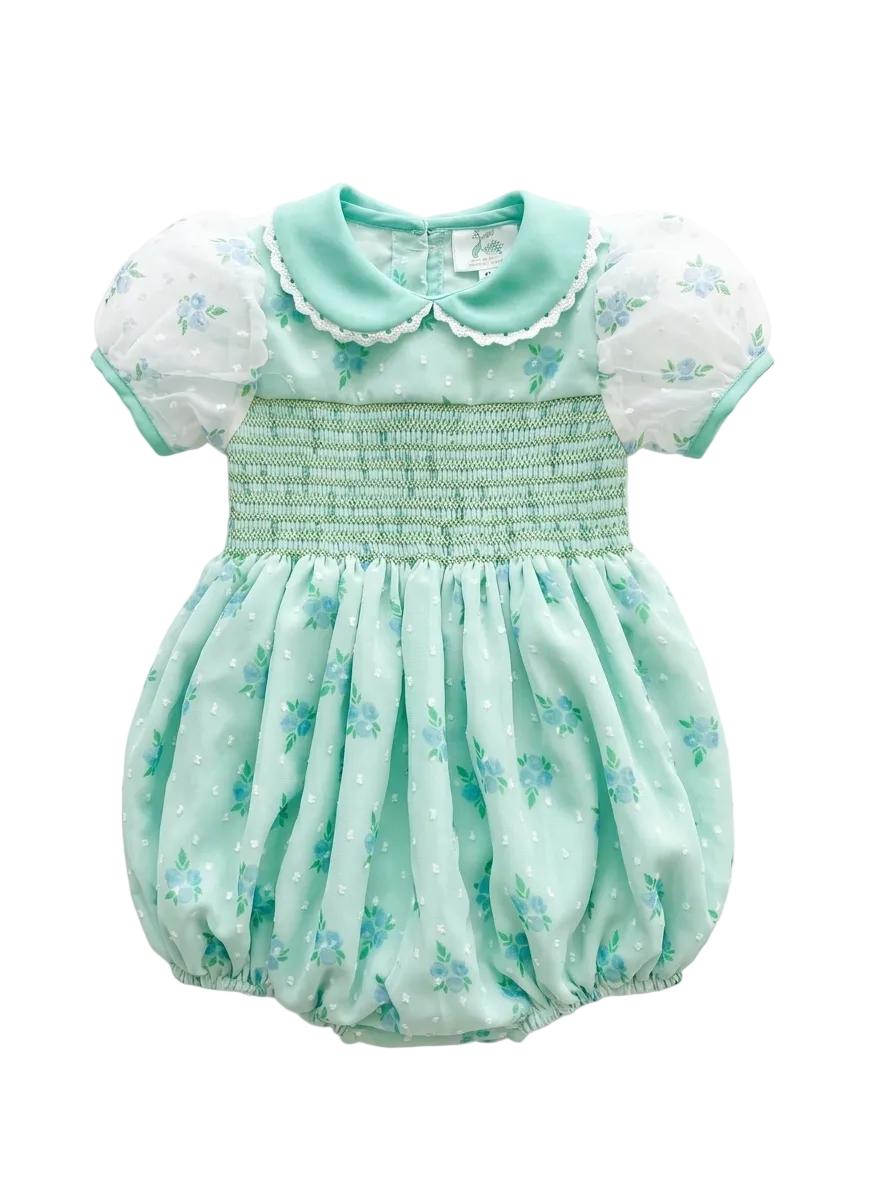 Mint green baby romper with floral patterns on a white background
