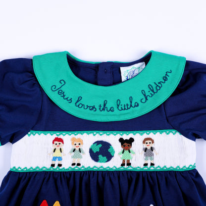 Front detail of embroidered green collar and hand smocked chest panel with kids and globe on navy top.