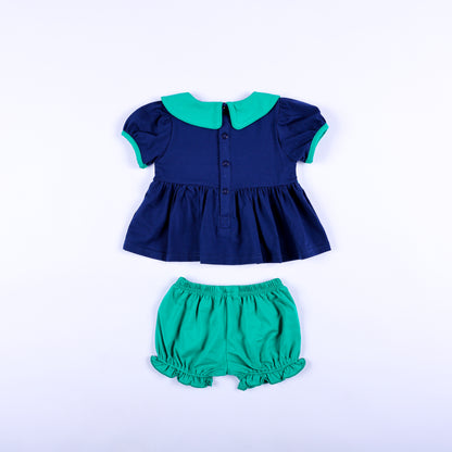 Full back view of Jesus Loves the Little Children navy smocked top with buttons and green bloomer shorts.