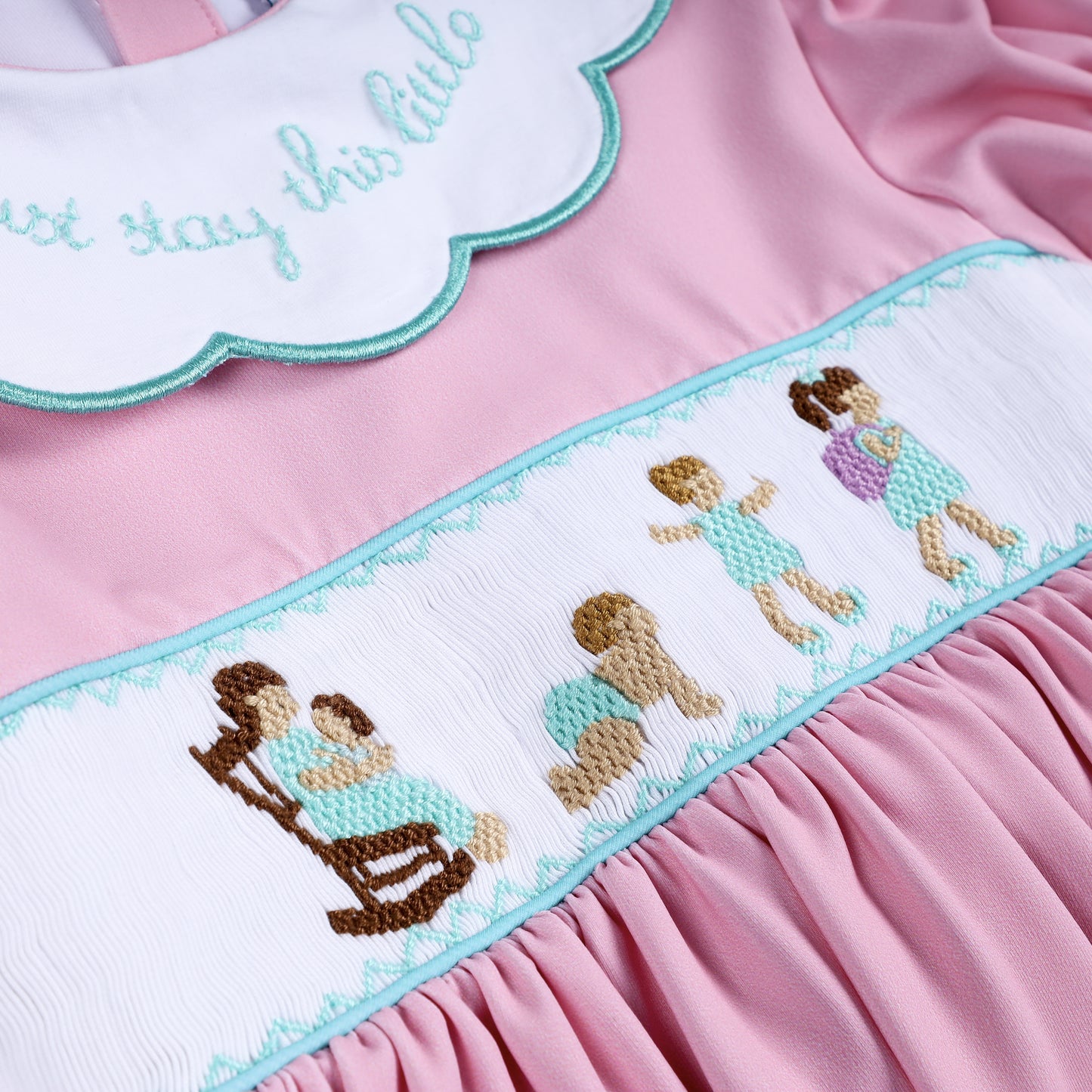 Intricate hand-smocked embroidery panel depicting mother and child growing up on pink bloomer dress top.
