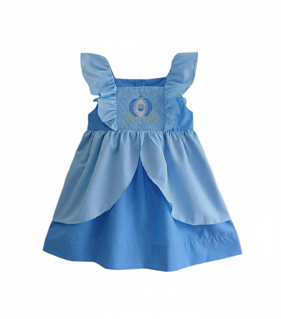 Flat lay front view of the light blue smocked Cinderella princess dress showing carriage embroidery and ruffles.