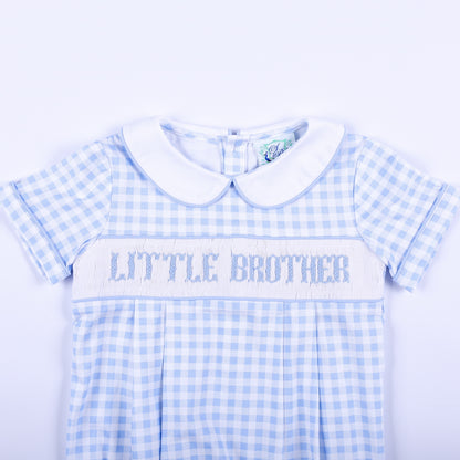 Detailed view of hand-smocked Little Brother embroidery on a light blue gingham baby boy bubble outfit.