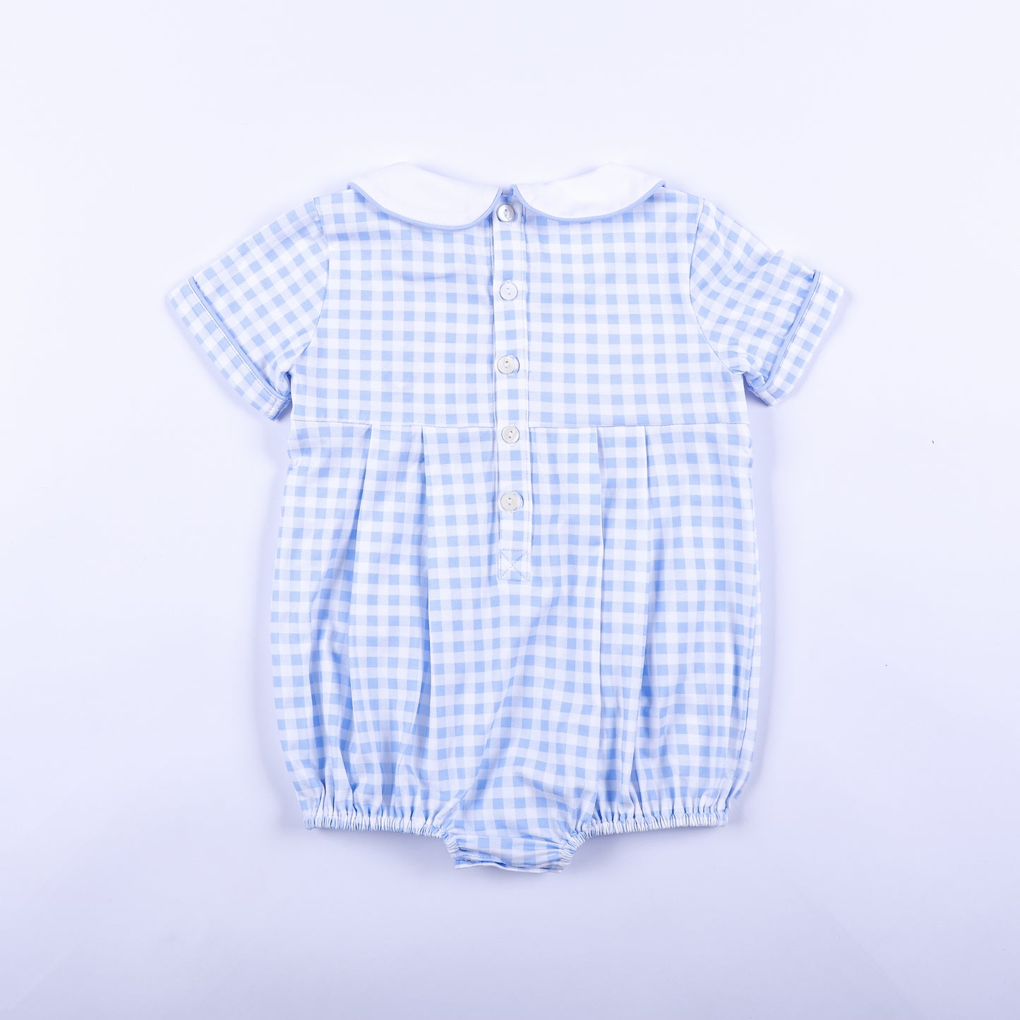 Full back view of light blue gingham smocked baby boy bubble romper featuring classic button closures.