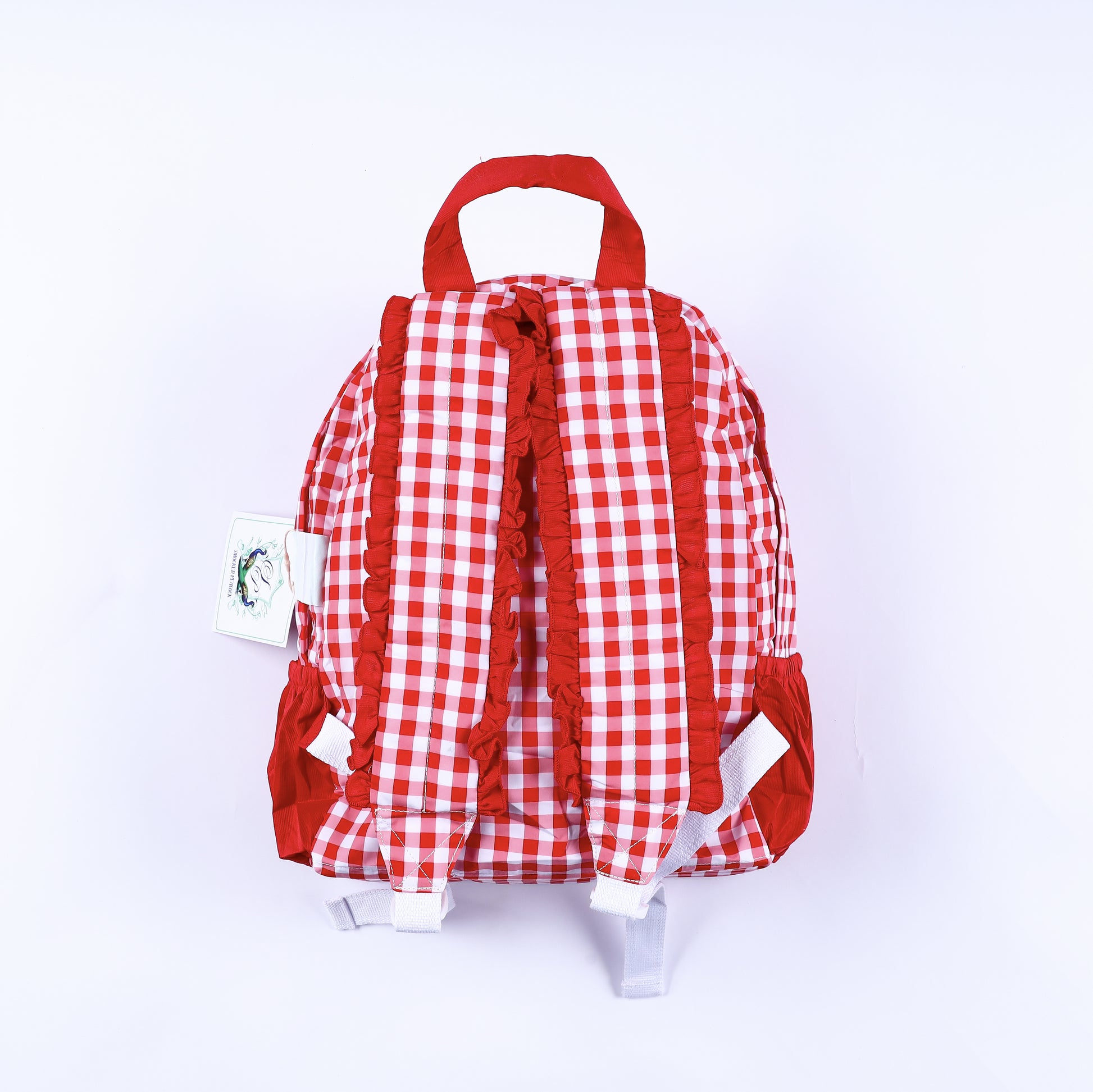 Back view of red gingham full size kids backpack showcasing red ruffle trimmed padded shoulder straps.