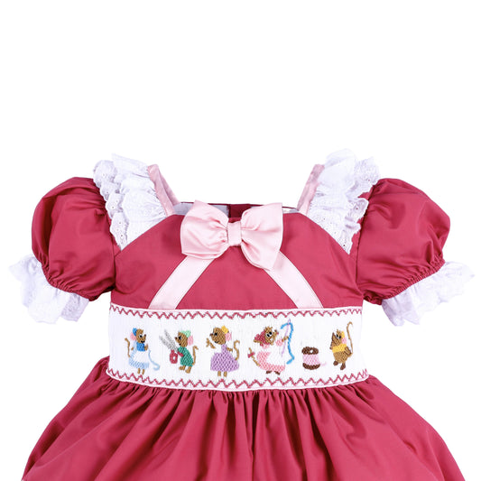 Hand smocked bodice detail on pink princess dress featuring embroidered sewing mice and a satin chest bow.