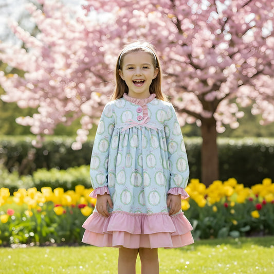 Girl wearing Nutcracker Ballet aqua blue and pink nightgown with ruffled trim in a blooming spring garden.