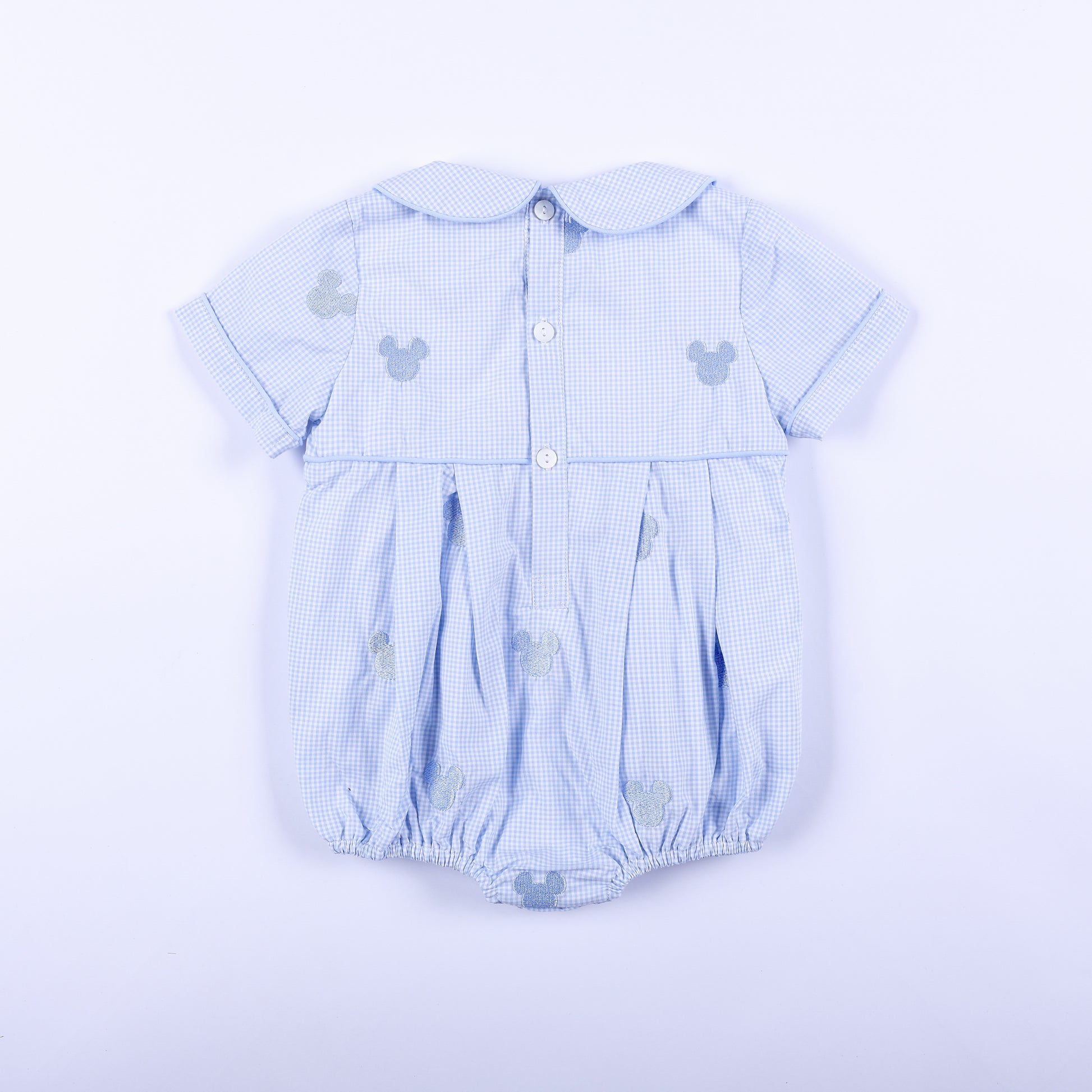 Full back view of light blue gingham Oh Twodles hand smocked boys bubble displaying back button closure details.