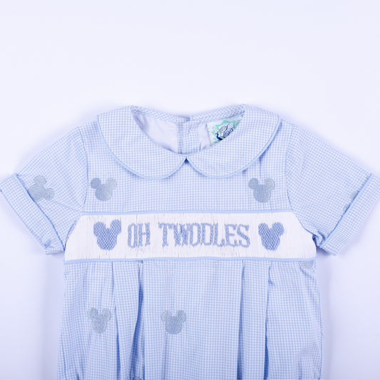 Close-up front view of Oh Twodles hand smocked boys bubble showing Peter Pan collar and hand embroidered chest band.