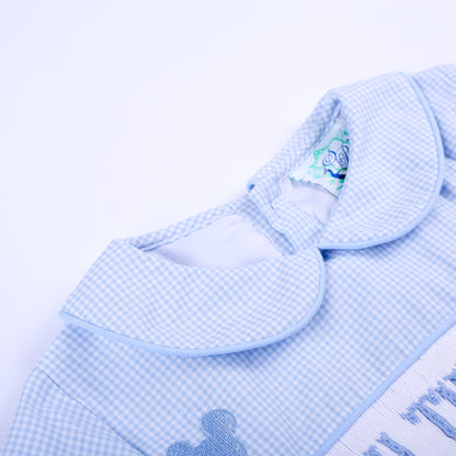 Close-up shot of neat Peter Pan collar and soft inner neck lining of Oh Twodles hand smocked blue gingham boys bubble.