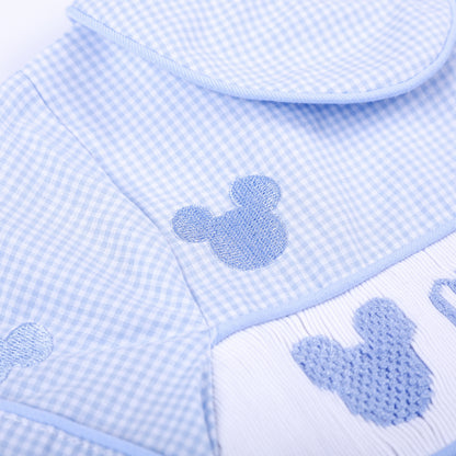 Macro view of light blue embroidered mouse motif and delicate smocked stitching on boys gingham Oh Twodles bubble.