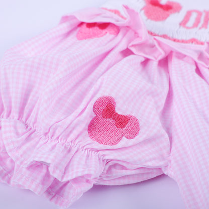 Detailed view of elastic ruffled leg opening and embroidered mouse head on pink gingham hand smocked bubble.