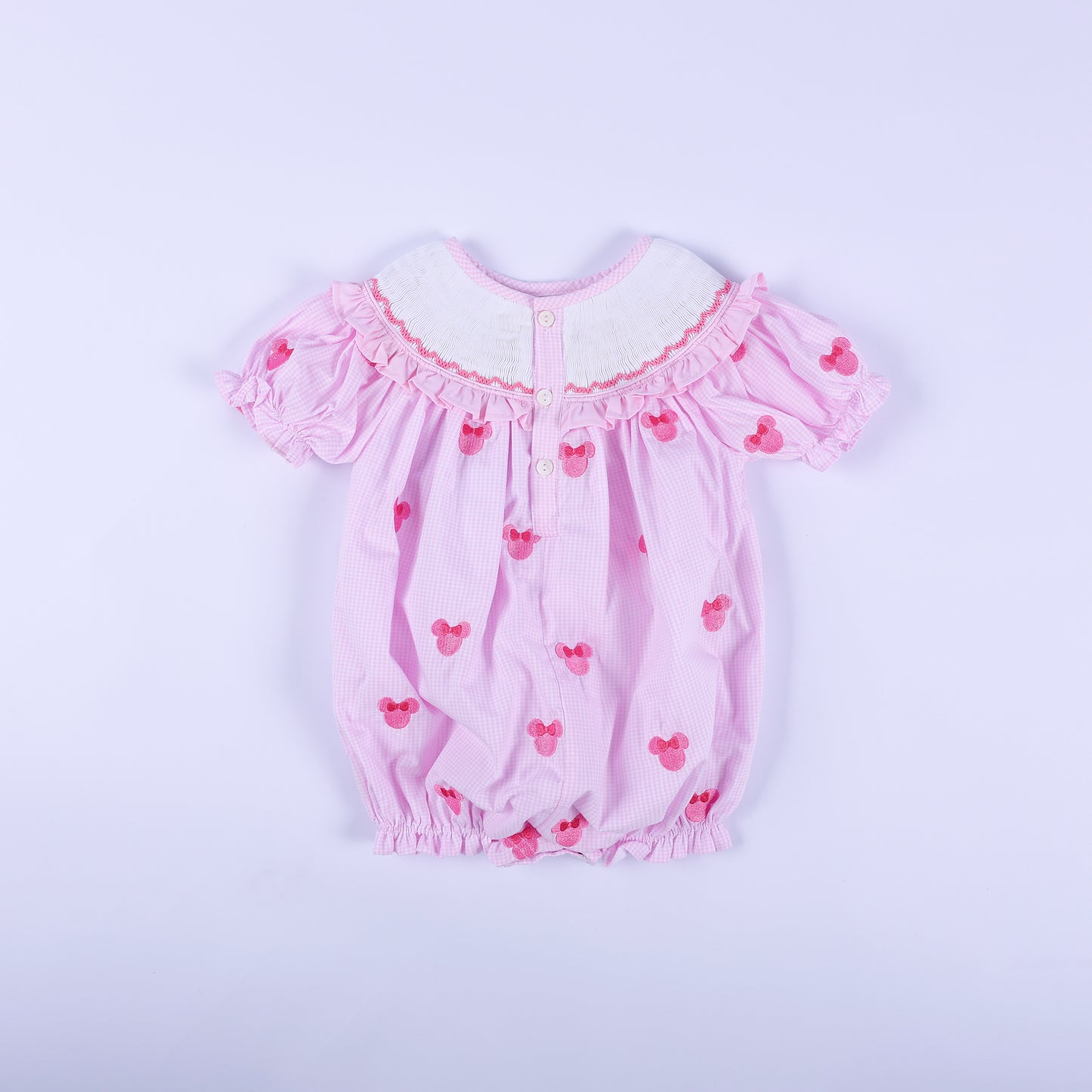 Back view of pink gingham Oh Twoodles hand smocked bubble romper featuring back button closures and puff sleeves.
