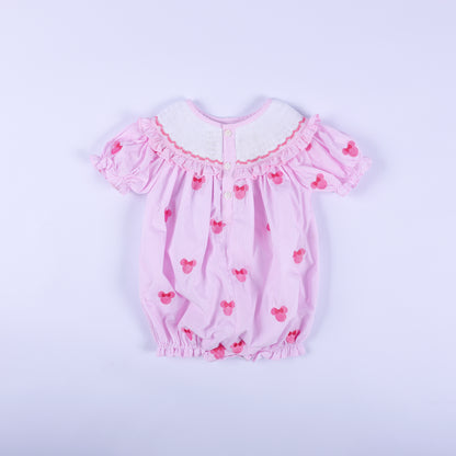 Back view of pink gingham Oh Twoodles hand smocked bubble romper featuring back button closures and puff sleeves.