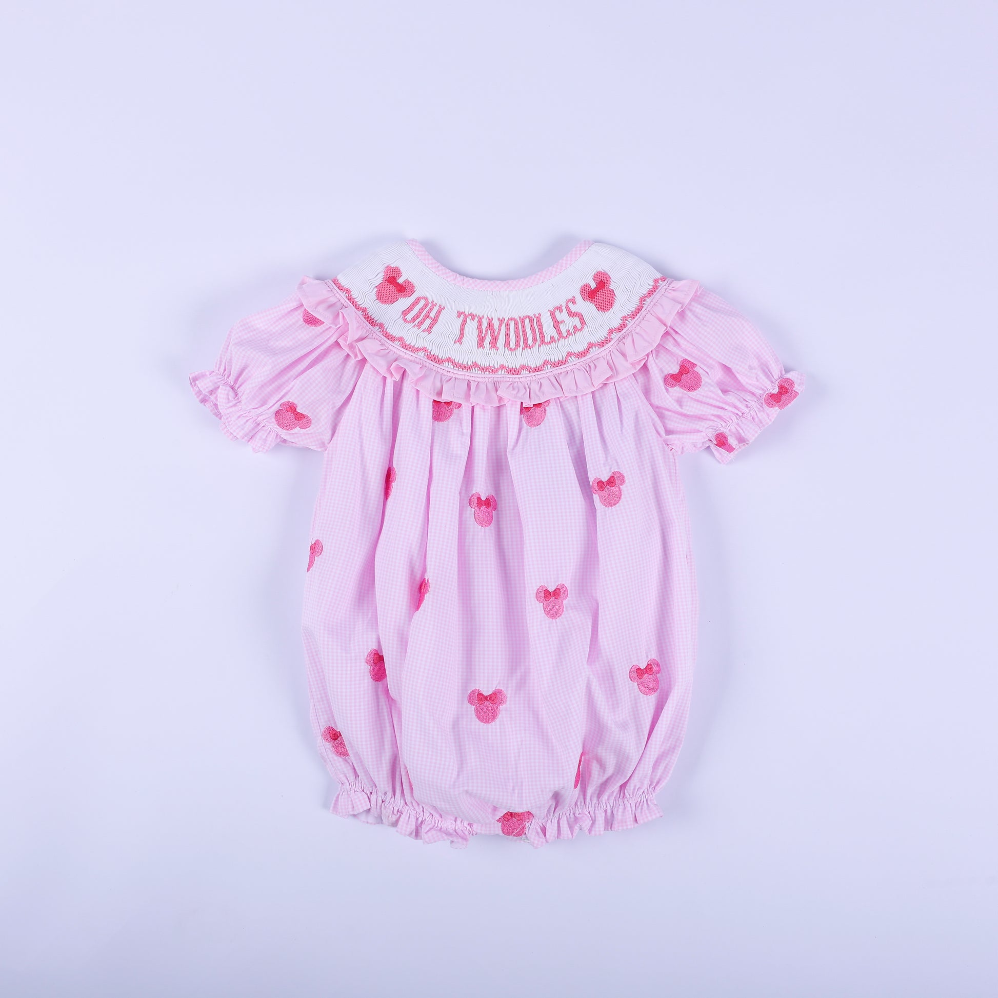 Oh Twoodles pink gingham hand smocked bubble romper with hand embroidered mouse details and ruffled sleeves.