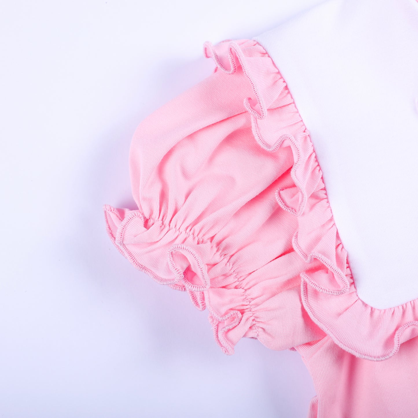 Close-up of ruffled flutter sleeve detail on a pink embroidered baby girl boutique bubble romper outfit.