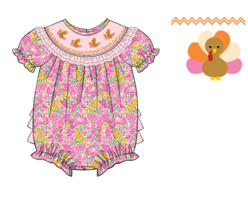 Baby girl's pink floral Thanksgiving bubble romper featuring ruffled sleeves and a light pink smocked collar with three embroidered turkeys.