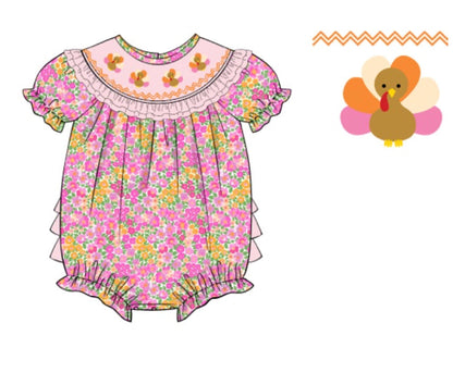 Baby girl's pink floral Thanksgiving bubble romper featuring ruffled sleeves and a light pink smocked collar with three embroidered turkeys.