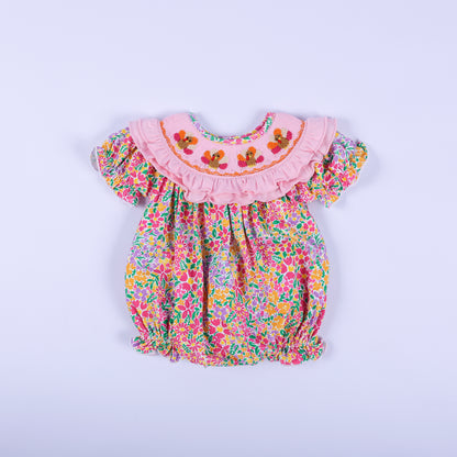 Pink floral Thanksgiving baby bubble romper with a smocked ruffled collar featuring three hand-embroidered turkeys.