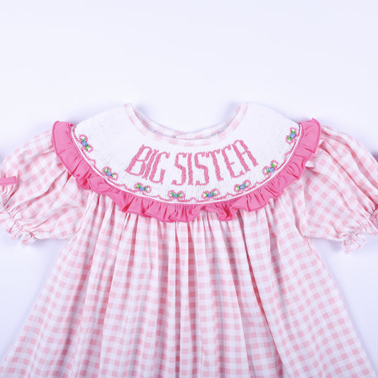 Close up front view of hand smocked Big Sister embroidered white ruffle collar on pink gingham outfit.