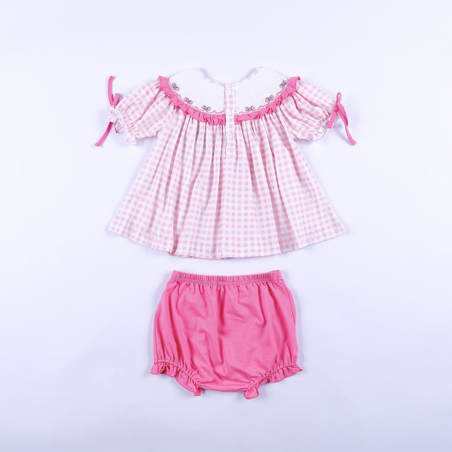 Back full view of pink gingham hand smocked Big Sister top with button closure and matching pink bloomers.