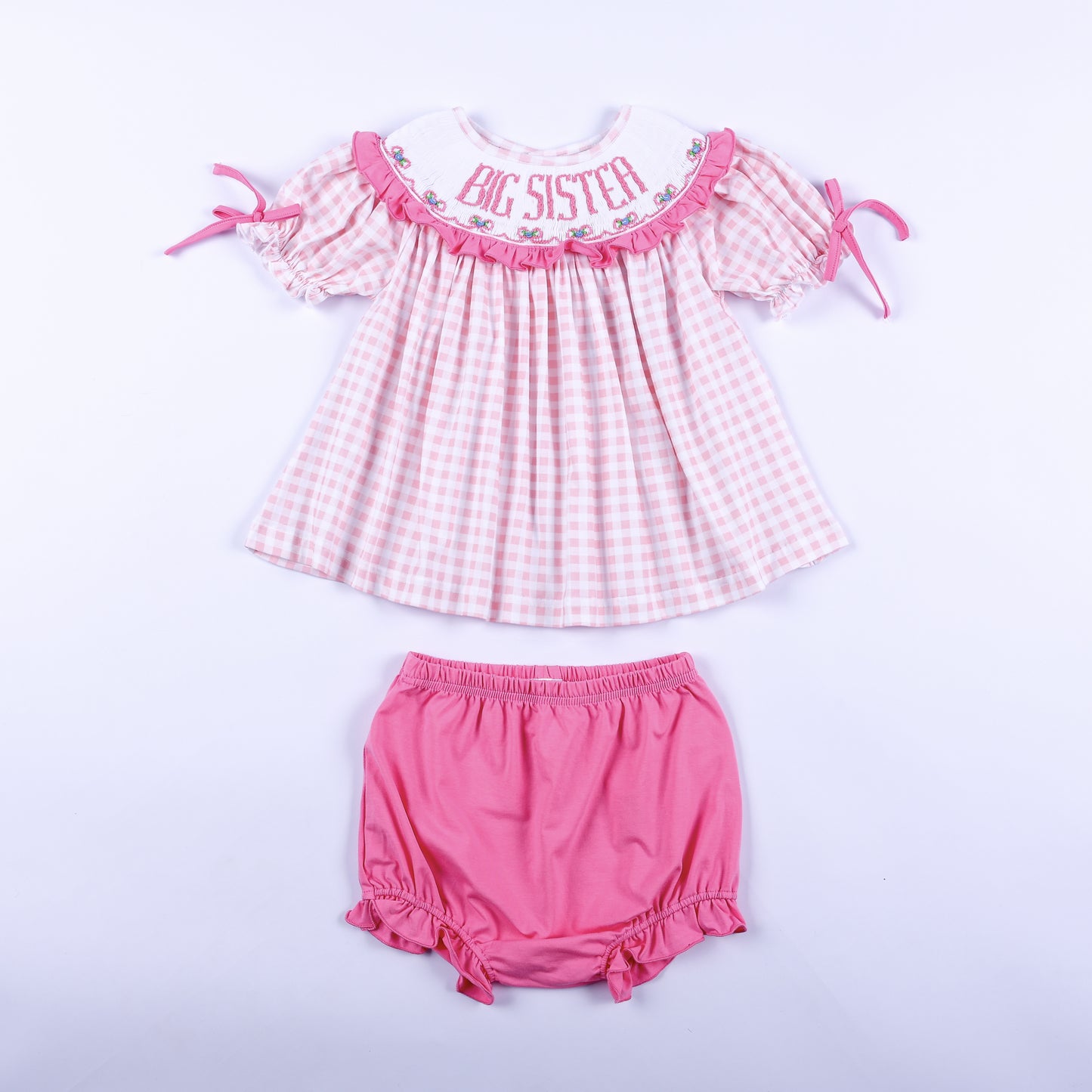 Pink gingham hand smocked Big Sister dress top with matching pink bloomer diaper cover set for toddler girls.
