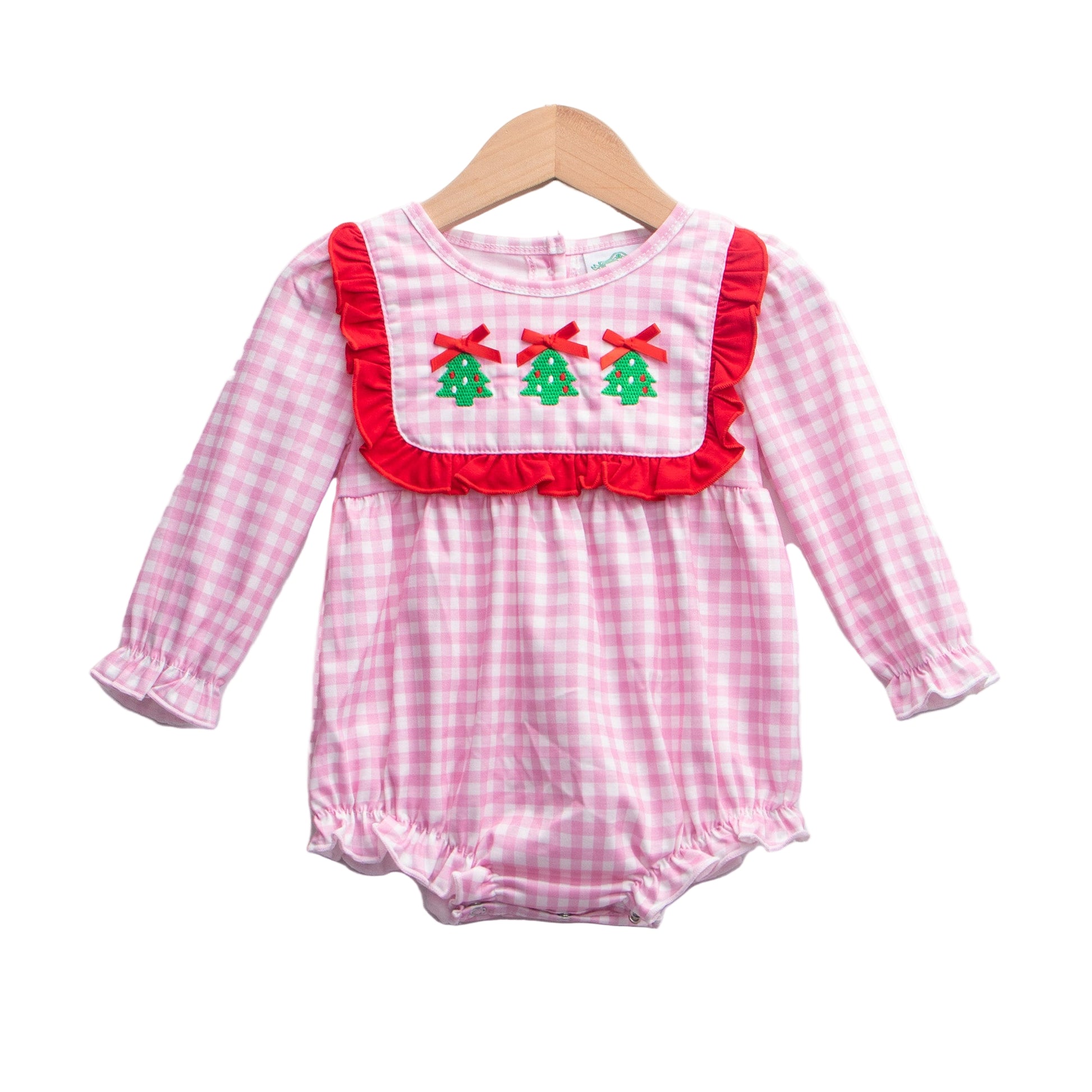 Baby girl pink gingham holiday romper featuring a red ruffle bib, long sleeves, and three embroidered Christmas trees.