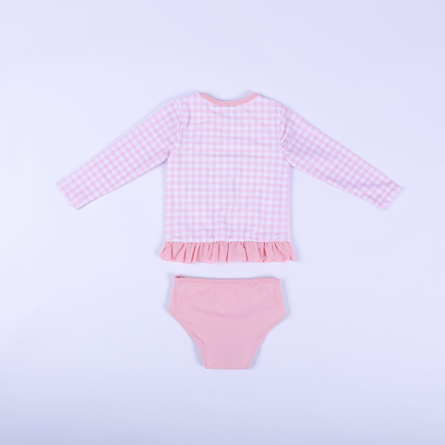 Back flat lay view of the pink gingham fairytale princess two piece swimsuit showing the solid pink bikini bottoms.