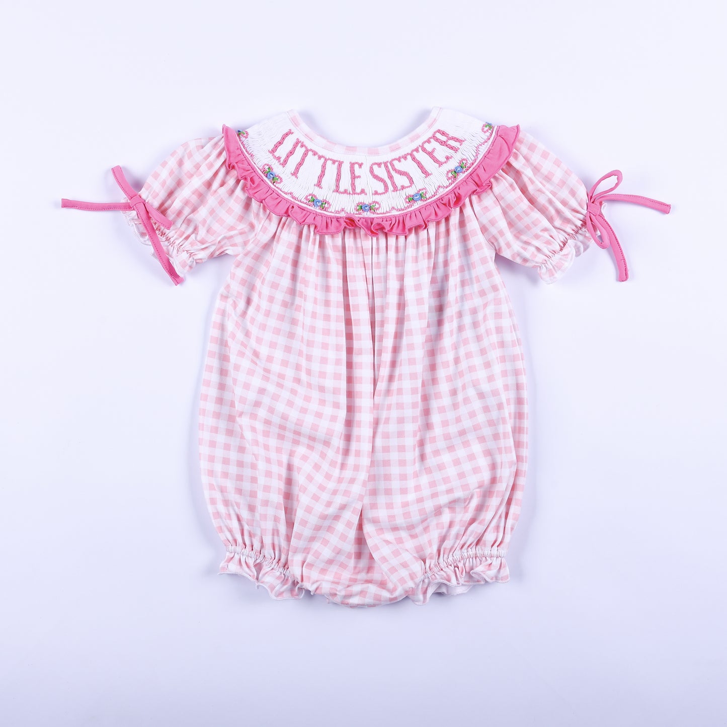 Front view of baby girls pink gingham hand smocked Little Sister bubble romper outfit with embroidered collar.