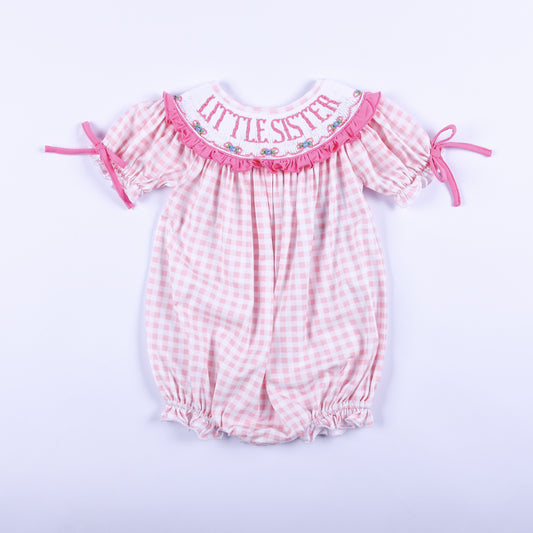 Front view of baby girls pink gingham hand smocked Little Sister bubble romper outfit with embroidered collar.