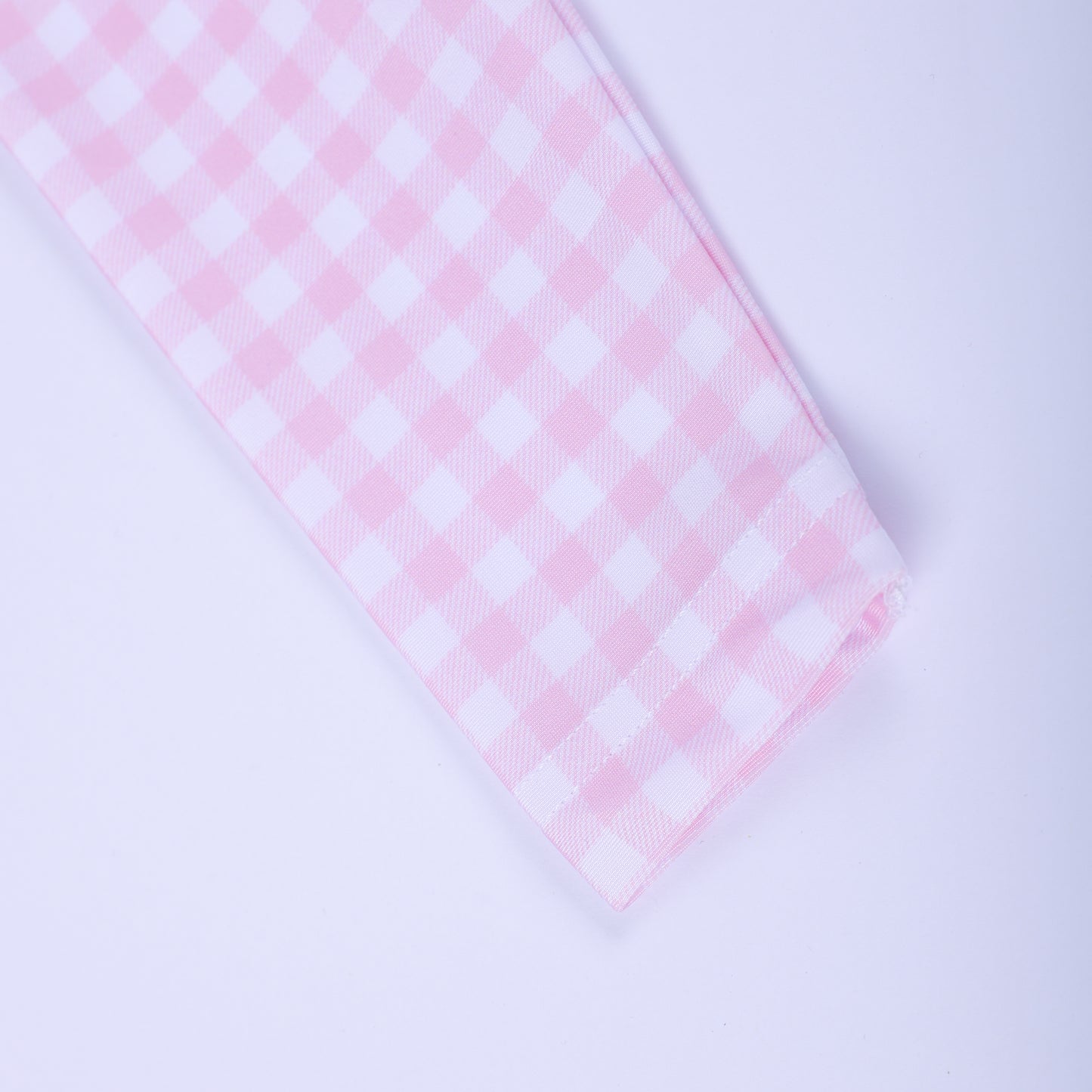 Close up view of the long sleeve cuff on the pink and white gingham fairytale princess girls rash guard swim shirt.